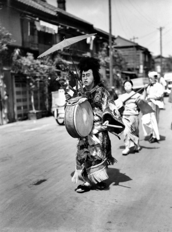 A-Japanese-man-in-costume-beats-the-drum-762x1024